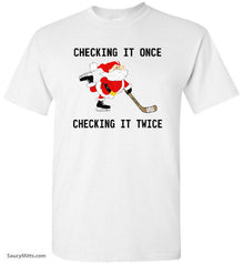 White t-shirt with a graphic of Santa Claus playing hockey and text 'Checking it once, checking it twice'.