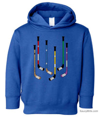 A royal blue toddler pullover hoodie featuring a graphic print of six hockey sticks in various colors on the front.